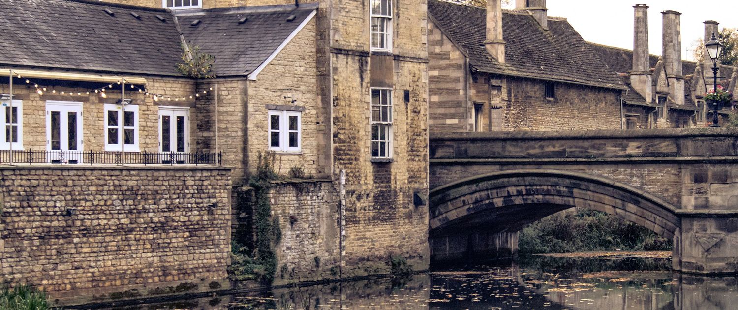 Historic stone buildings and bridge by the river in Stamford